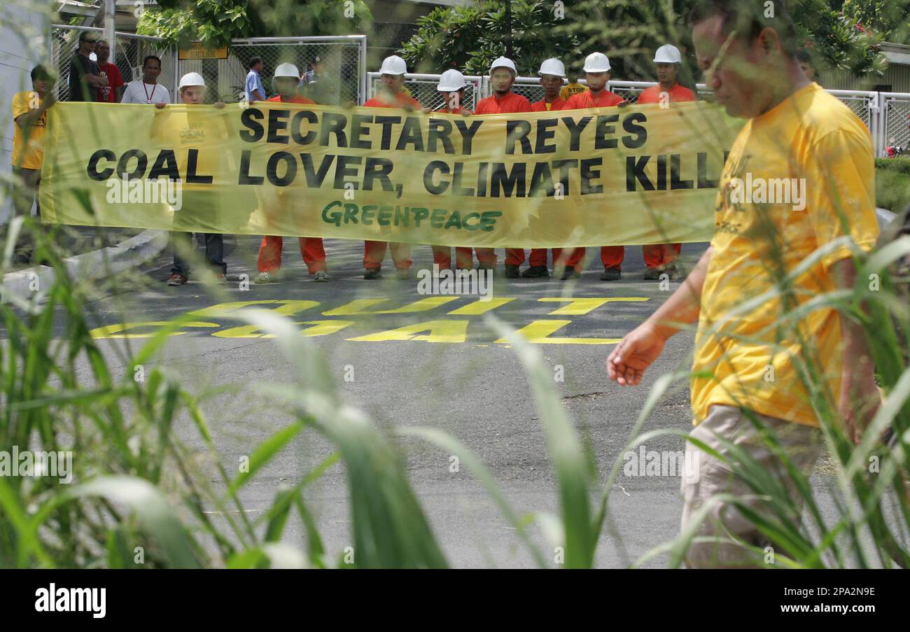 Activists from the environmentalist group Greenpeace display a banner
