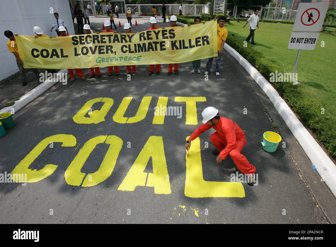 Activists from the environmentalist group Greenpeace paint the words