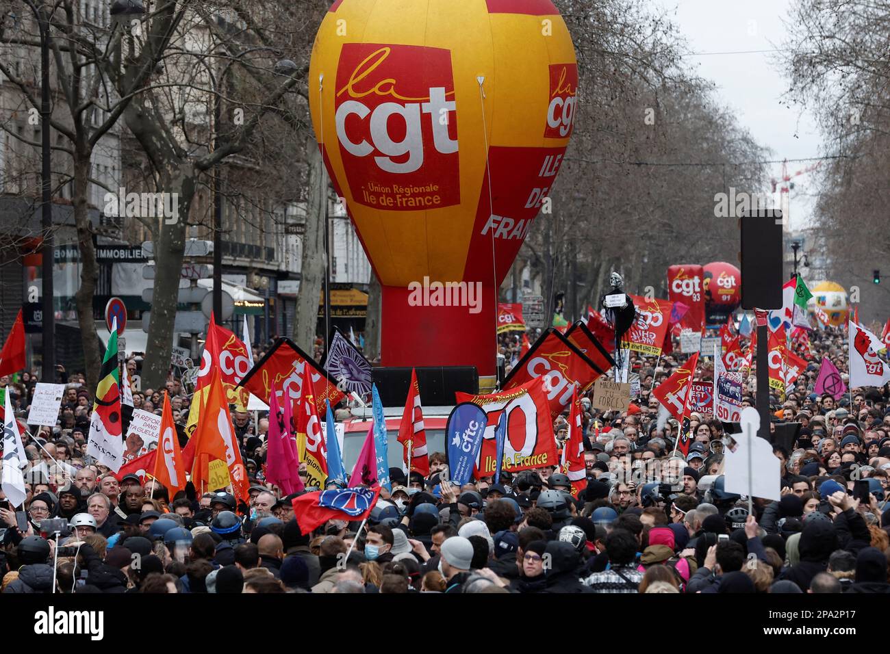 General Confederation of Labour (CGT) trade union signs are seen as demonstrators march against the government's pension reform plan in Paris, France, March 11, 2023. REUTERS/Benoit Tessier Stock Photo