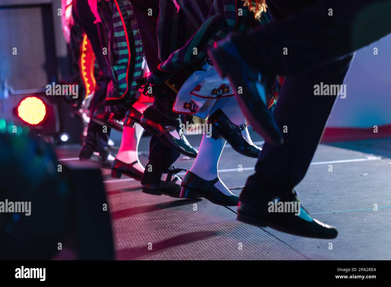 Sofia, Bulgaria - circa 2023 - Traditional Bulgarian dancers on the stage of a conference feet moving in unison. Stock Photo