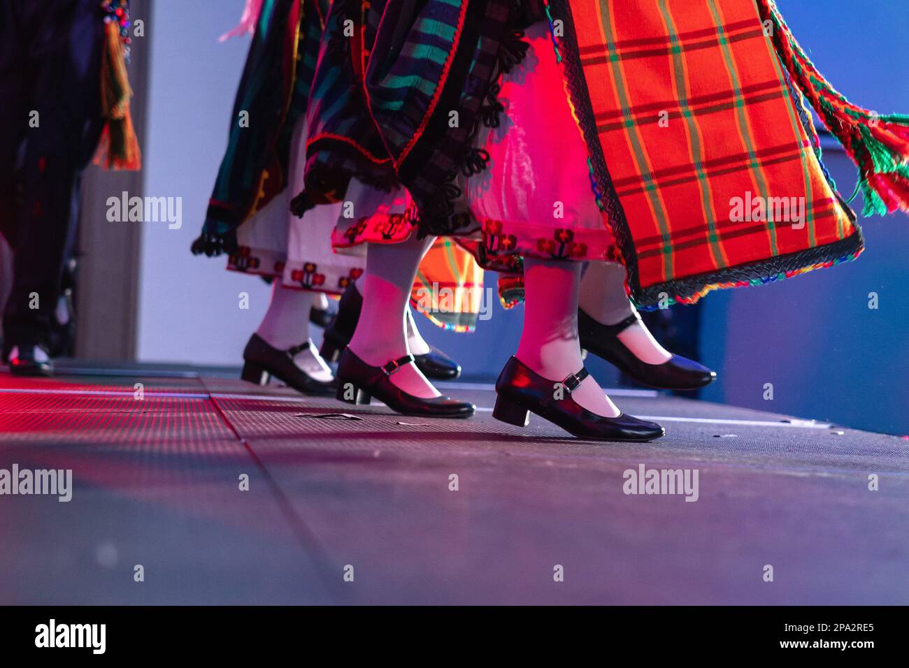 Sofia, Bulgaria - circa 2023 - Traditional Bulgarian dancers on the stage of a conference feet moving in unison. Stock Photo