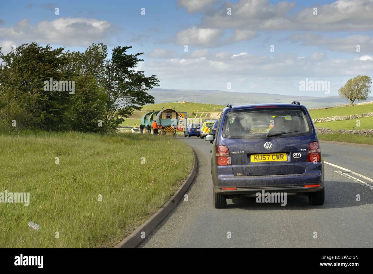 Traffic jam behind horsedrawn gypsy carts on the road to Appleby Fair
