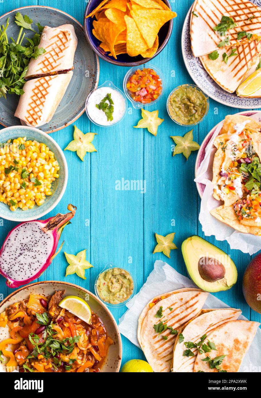 Traditional Mexican food background. Table with different Mexican dishes. Cheese nachos, tacos