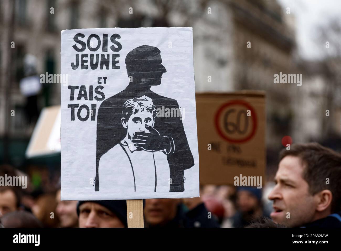 A demonstrator holds a placard at a march against the government's pension reform plan in Paris, France, March 11, 2023. The placard reads: 'Be young and shut up'.  REUTERS/Benoit Tessier Stock Photo