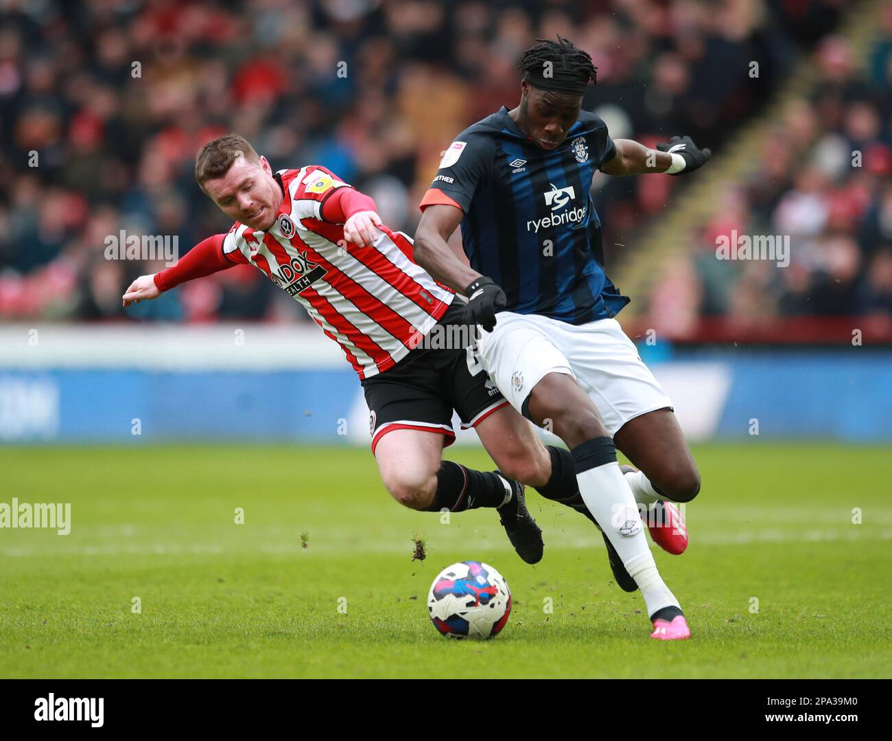 Sheffield, UK. 11th Mar, 2023. John Fleck of Sheffield Utd muscled off the ball by Elijah Adebayo of Luton Town during the Sky Bet Championship match at Bramall Lane, Sheffield. Picture credit should read: Simon Bellis/Sportimage Credit: Sportimage/Alamy Live News Stock Photo
