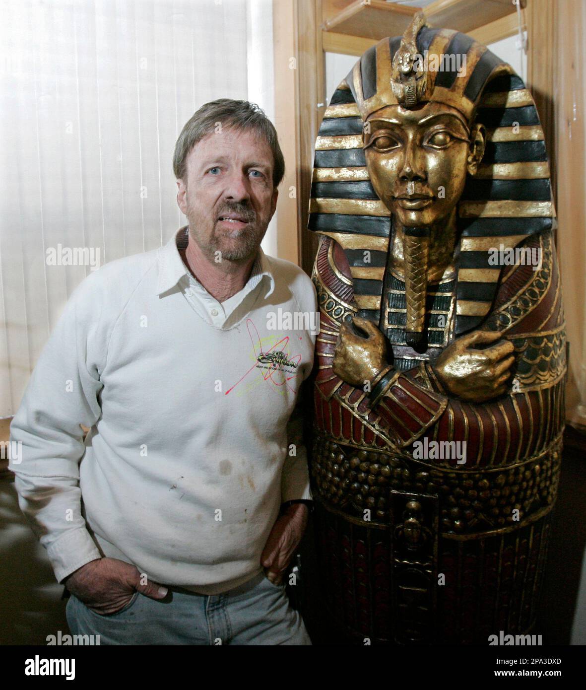 V Don Boeke poses next to a replica of an Egyptian coffin in his