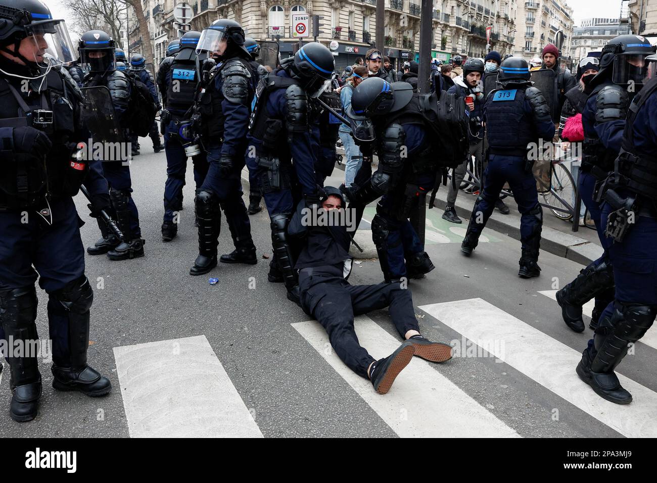Police officers detain a demonstrator during a march against the government's pension reform plan in Paris, France, March 11, 2023.  REUTERS/Benoit Tessier     TPX IMAGES OF THE DAY Stock Photo