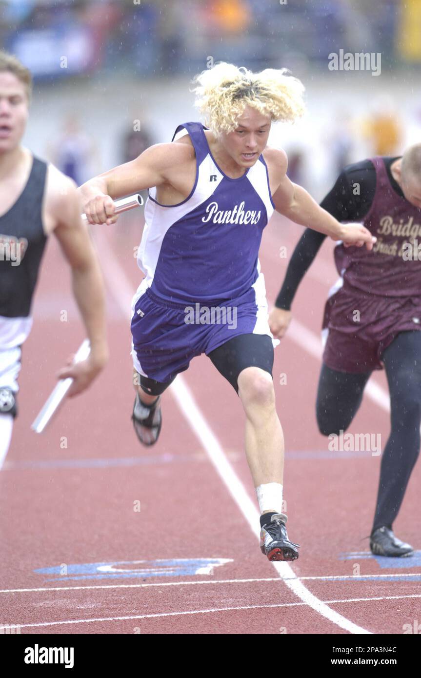 Sheridan's Justin Clark, center, leans into the finish line, but not