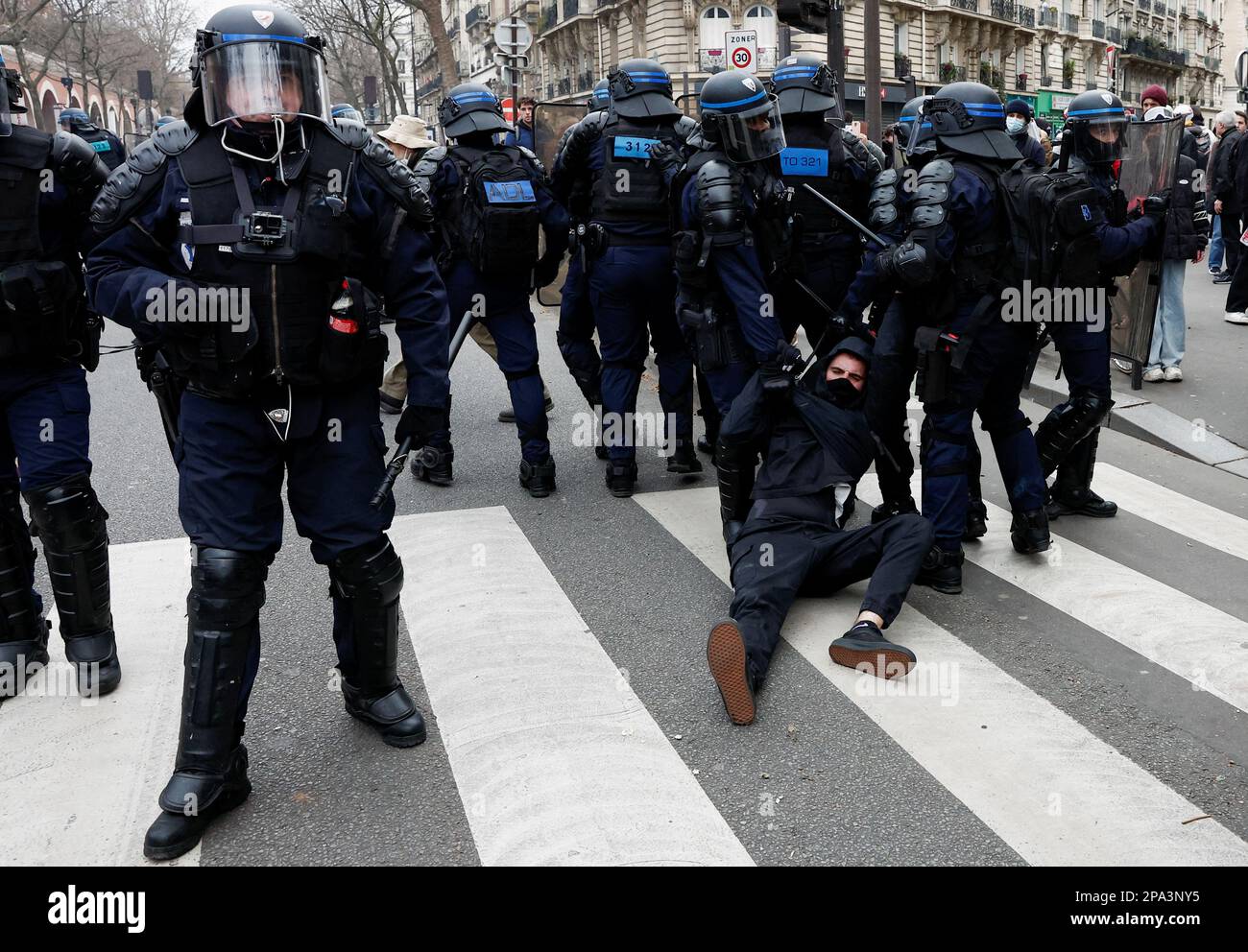 Police officers detain a demonstrator during a march against the government's pension reform plan in Paris, France, March 11, 2023.  REUTERS/Benoit Tessier Stock Photo