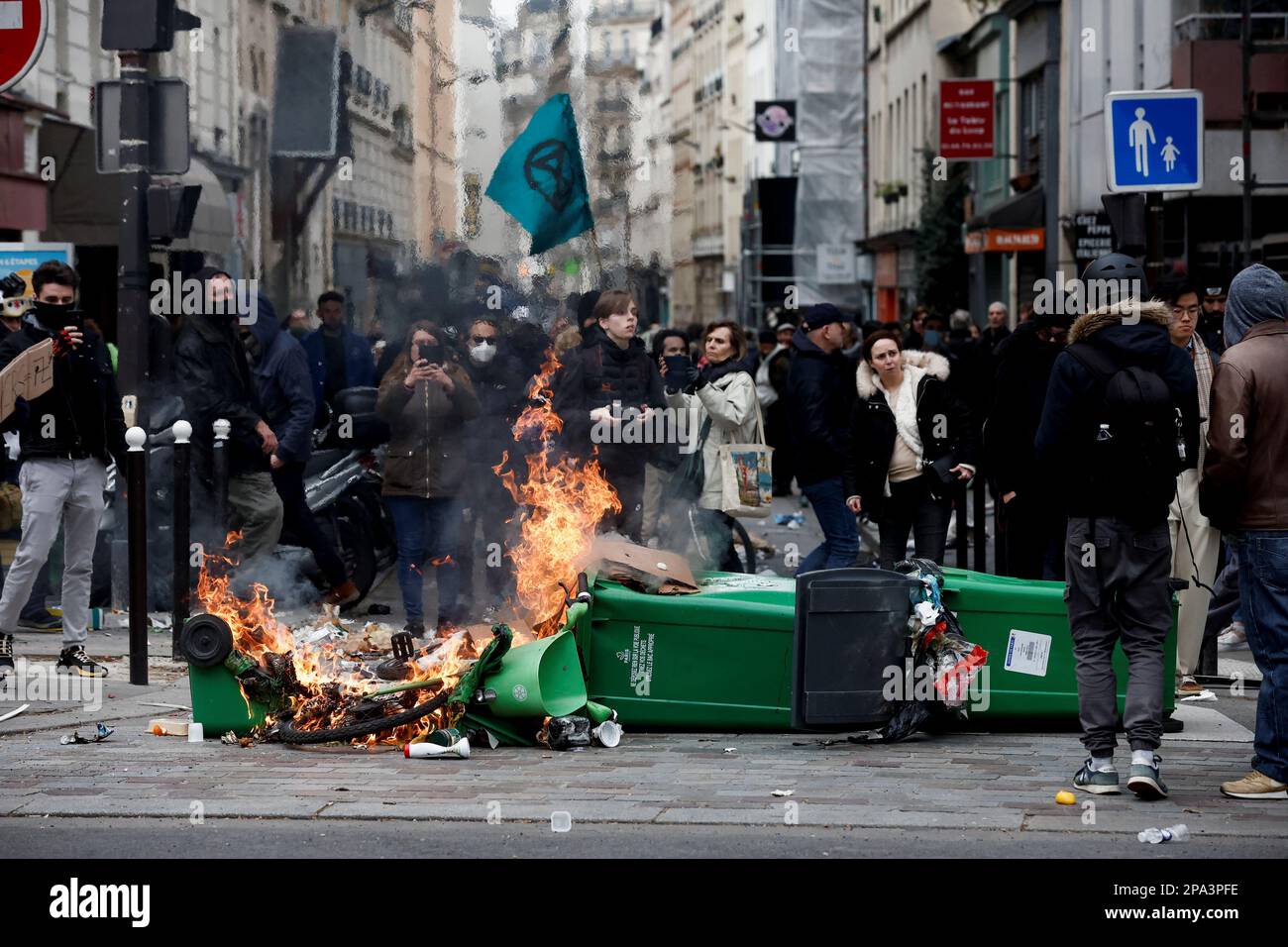Flames emerge as people attend a march against the government's pension reform plan in Paris, France, March 11, 2023.  REUTERS/Benoit Tessier Stock Photo