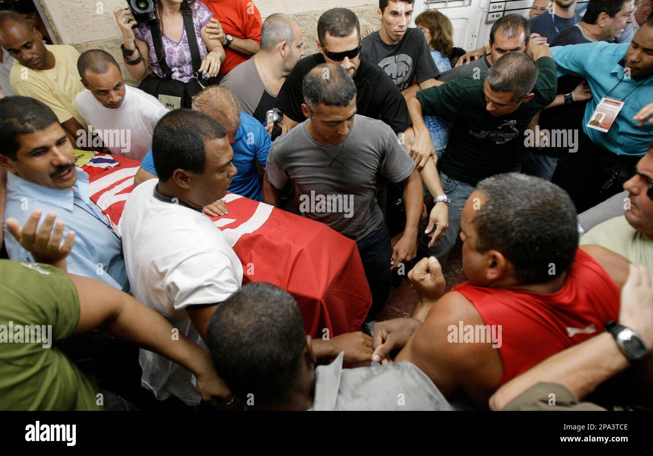 Former soccer star Romario, center, carries the coffin containing the body  of his father, Edevair de Souza Faria, who died from a heart attack, during  his funeral in Rio de Janeiro, Friday,