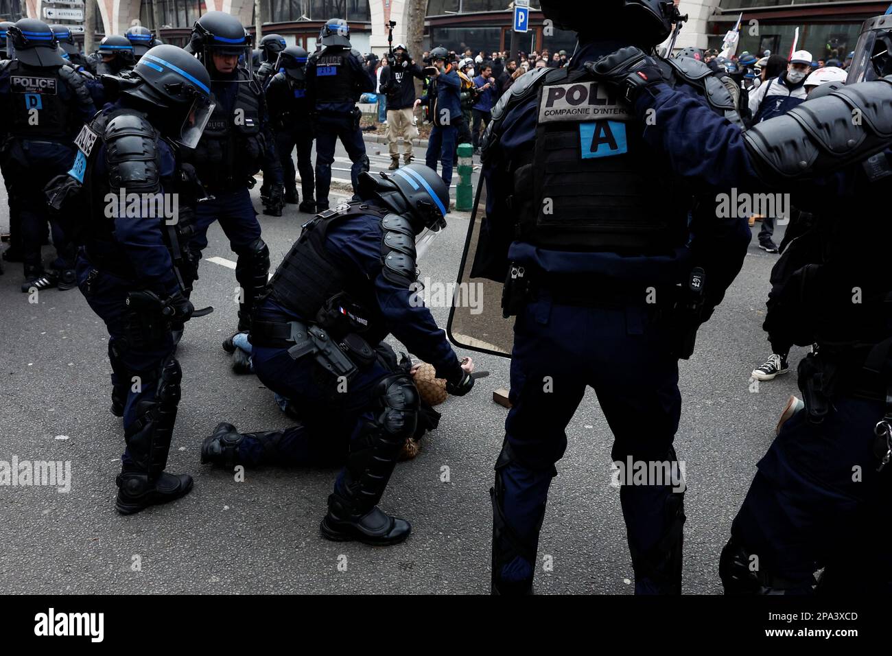 Police officers detain a demonstrator during a march against the government's pension reform plan in Paris, France, March 11, 2023.  REUTERS/Benoit Tessier Stock Photo