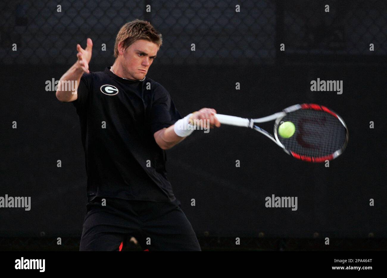 Travis Helgeson hits against Texas' Dimitar Kutrovsky in