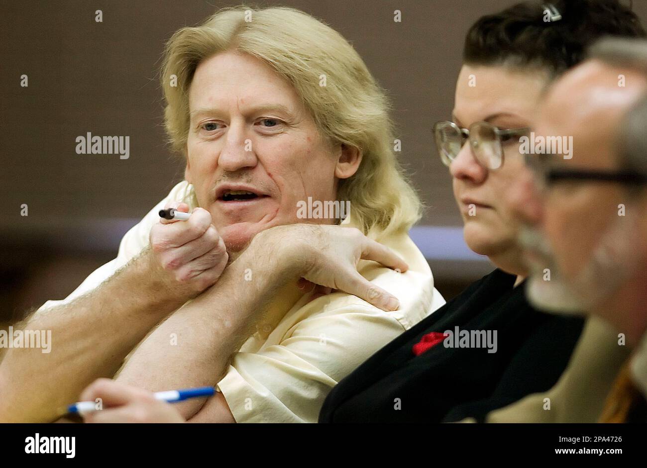 Defendant Richard Griswold left looks at evidence with defense Defendant Richard Griswold left looks at evidence with defense