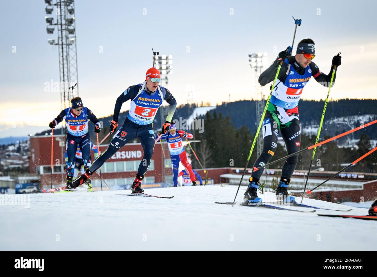ÖSTERSUND 20230311Italy's Daniele Cappellari (#7) followed by Germany's Roman Rees (#2) and Norway's Endre Strømsheim on the first leg of the men's 4x Stock Photo
