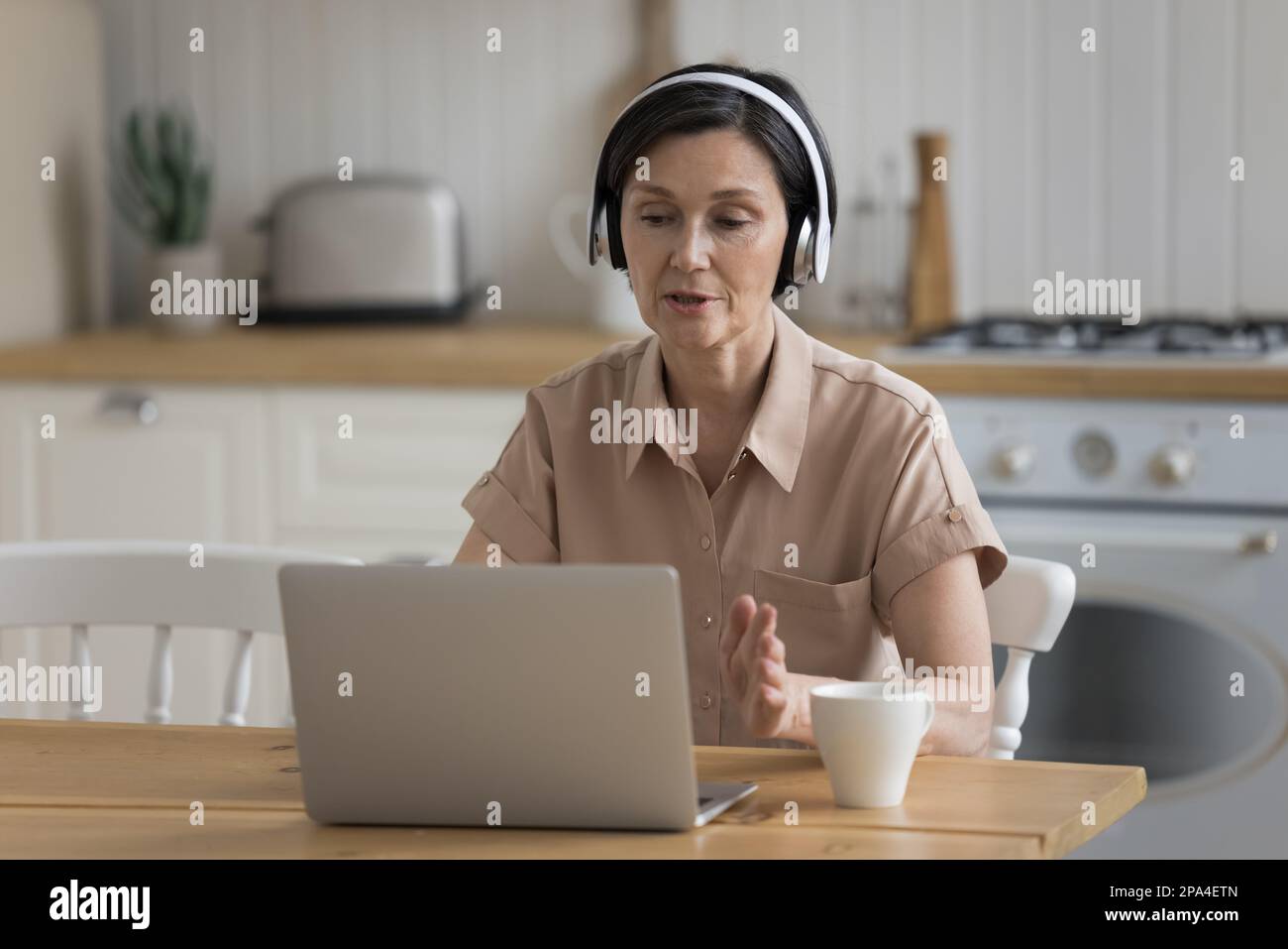 Focused busy senior coach, influencer woman giving lecture Stock Photo