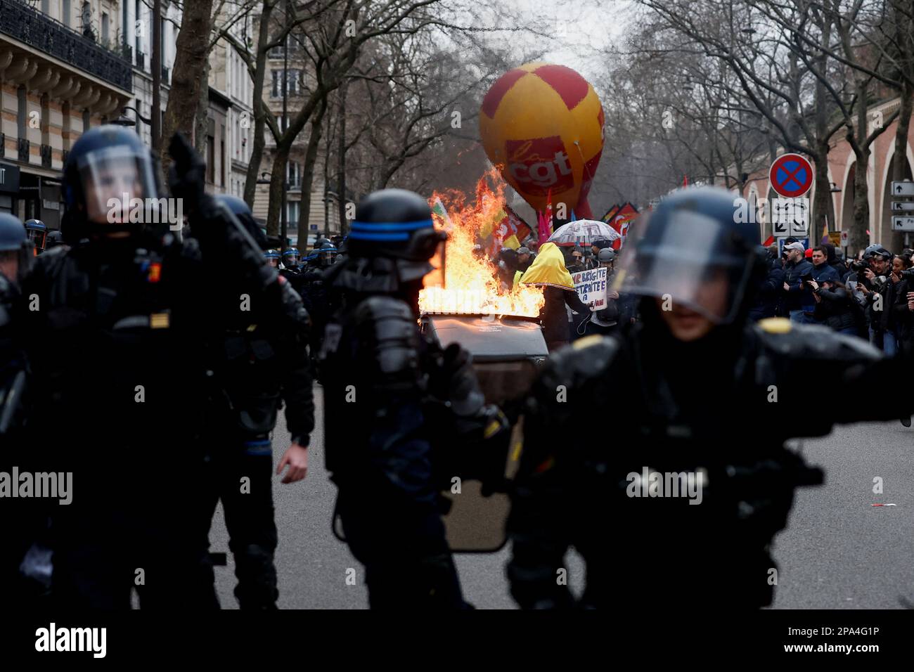 Police officers and demonstrators stand near flames during a march against the government's pension reform plan in Paris, France, March 11, 2023.  REUTERS/Benoit Tessier     TPX IMAGES OF THE DAY Stock Photo