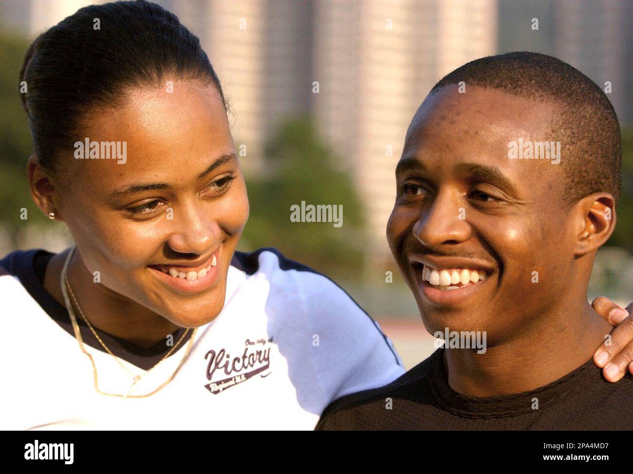** FILE ** In this Nov. 7, 2002 file photo, Marion Jones, left, and Tim Montgomery pose for photographers during a TAG Heuer's watch promotion in Hong Kong. Montgomery has been sentenced to 46 months in prison for his part in a fake-check scheme, Friday May 16, 2008 in White Plains, N.Y. Montgomery has a child with Marion Jones, the track superstar serving prison time for lying about the check scam and about her use of performance-enhancing drugs. ( AP Photo/Vincent Yu, File) Stock Photo