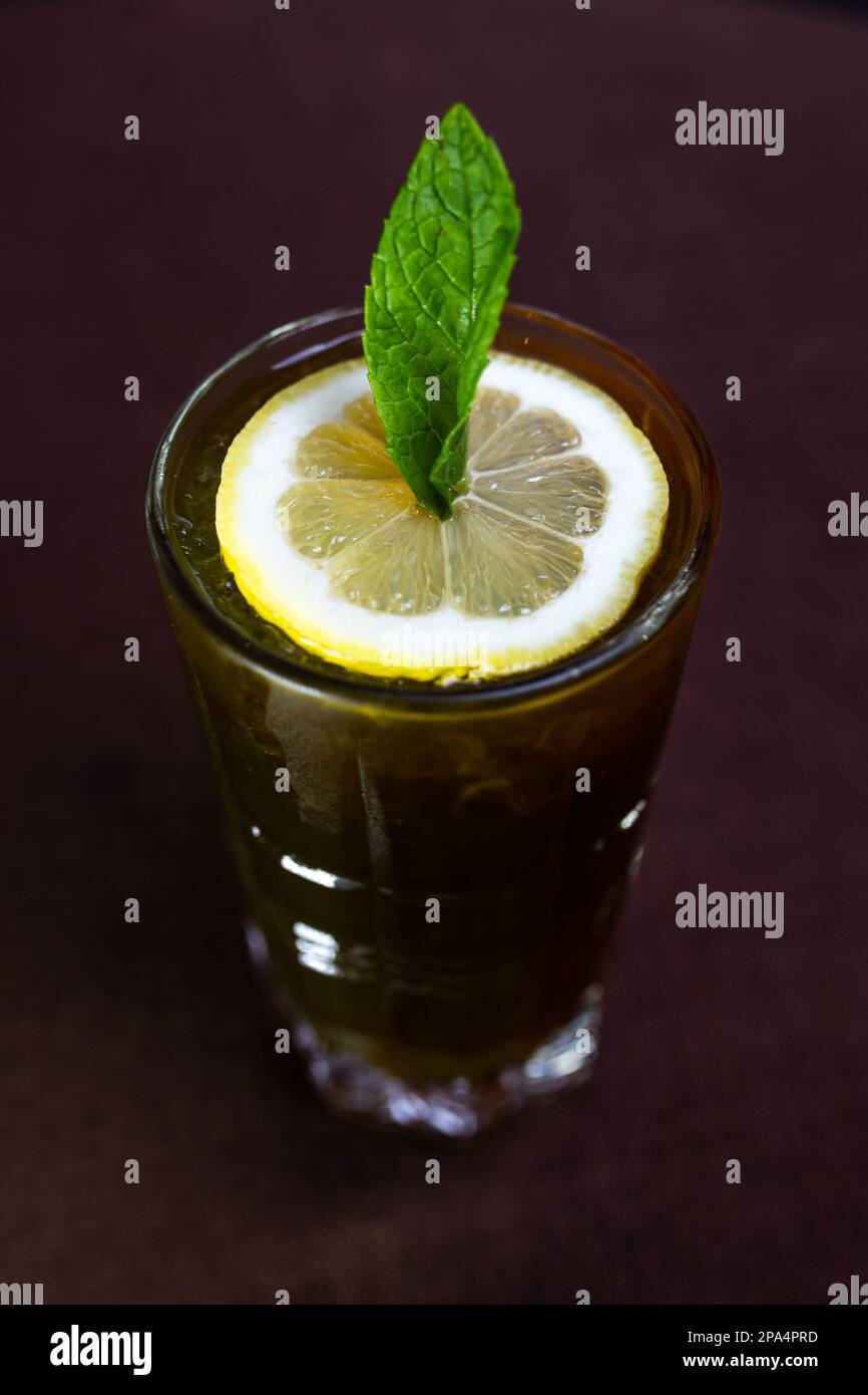 alcoholic drink with cocaCola and a slice of lemon in a glass Stock