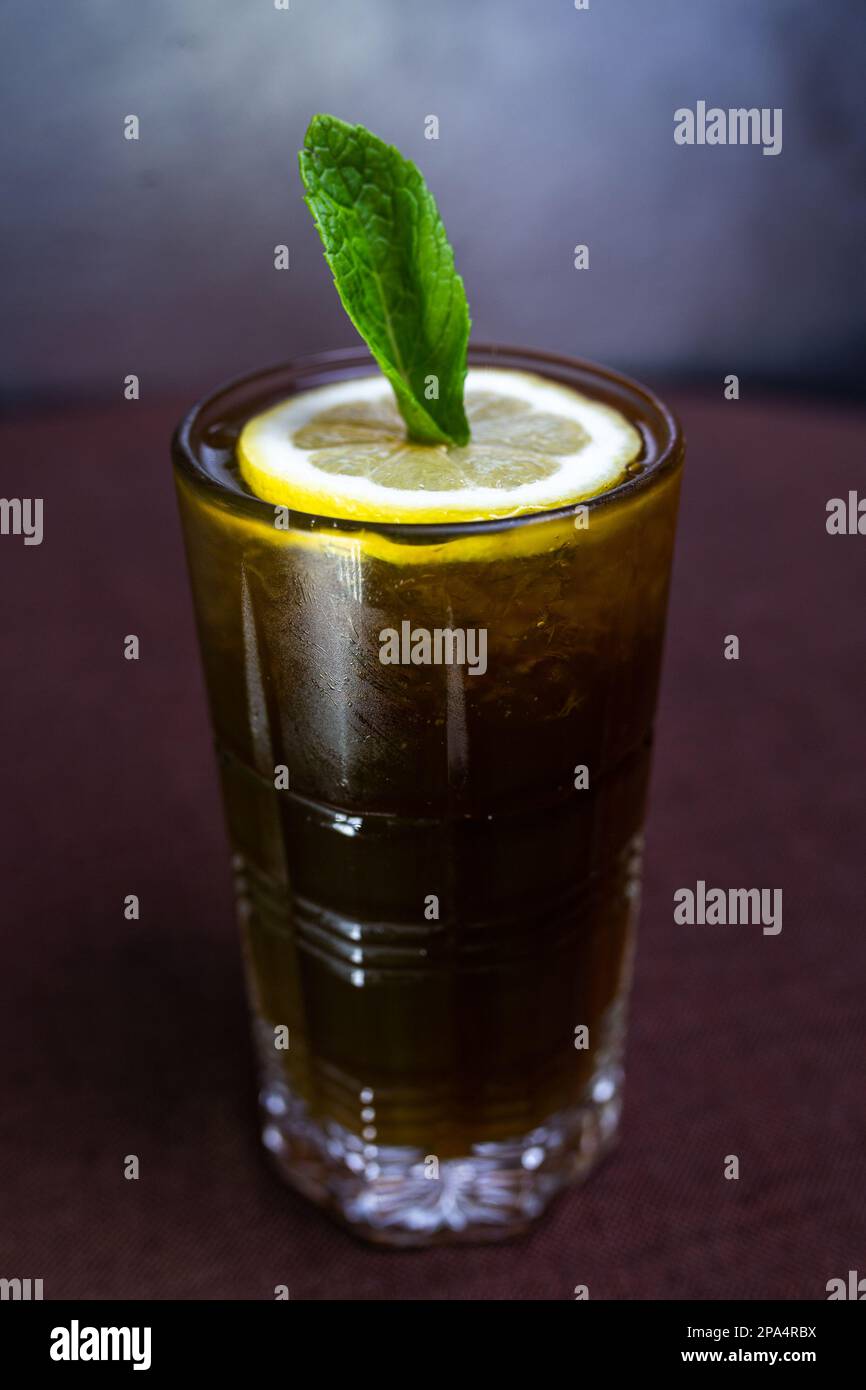alcoholic drink with cocaCola and a slice of lemon in a glass Stock