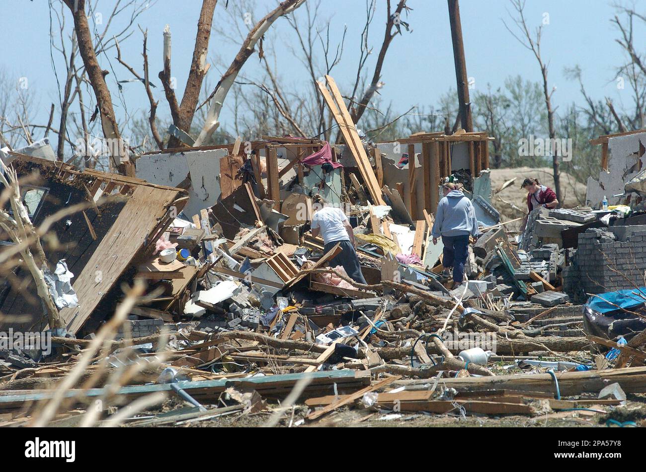 Residents sort through the remains of their home Sunday, May 11, 2008
