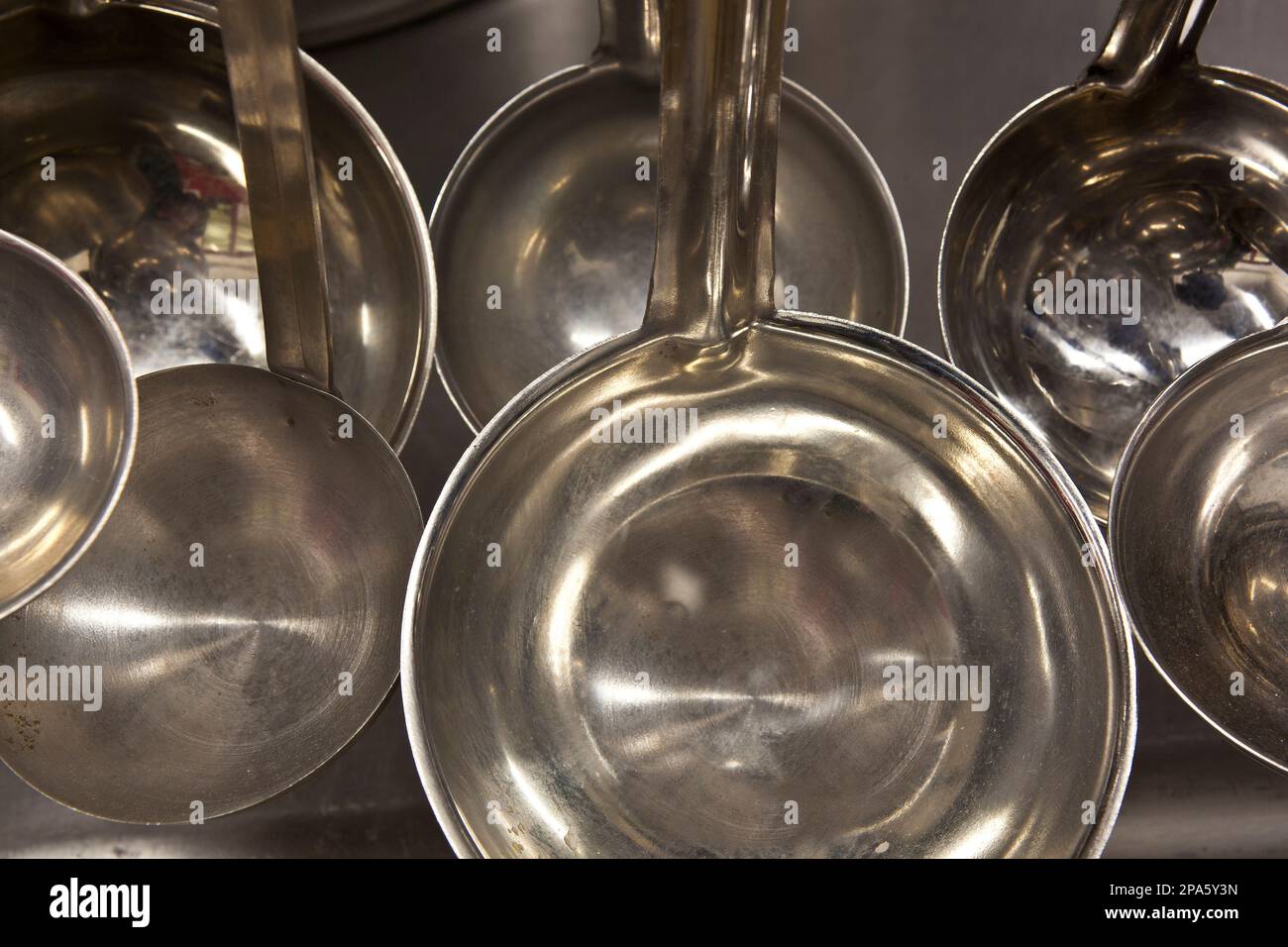 stainless steel pots and pans hanging in a commercial kitchen Stock Photo Alamy
