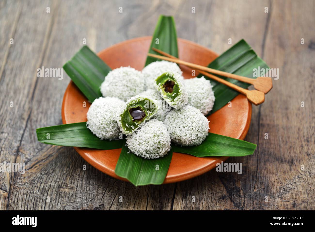 Onde-onde is a traditional Malaysian dessert consisting of green(made from pandan leaves juice) glutinous rice balls filled with palm sugar and coated Stock Photo