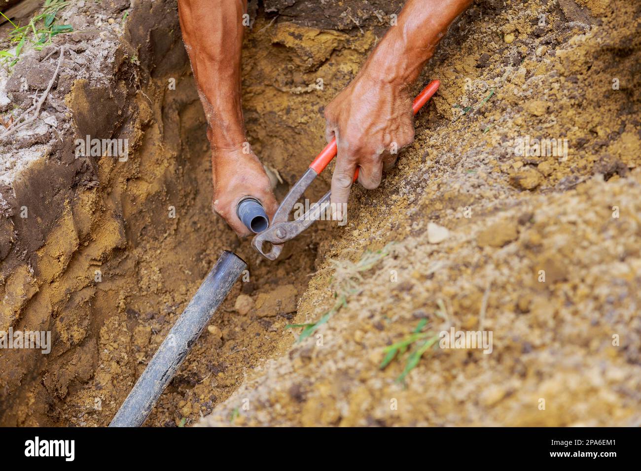 Installing an underground sprinkler system for watering yard garden man
