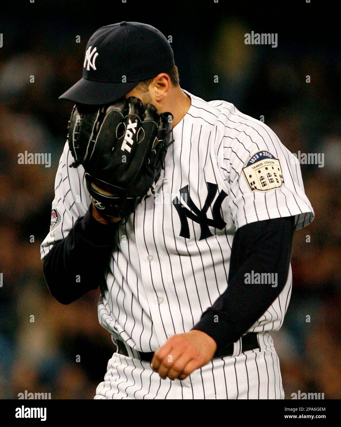 New York Yankees Andy Pettitte yells into his glove after giving up a  fifth-inning two-run home run to Detroit Tigers Marcus Thames in a baseball  game at Yankee Stadium in New York