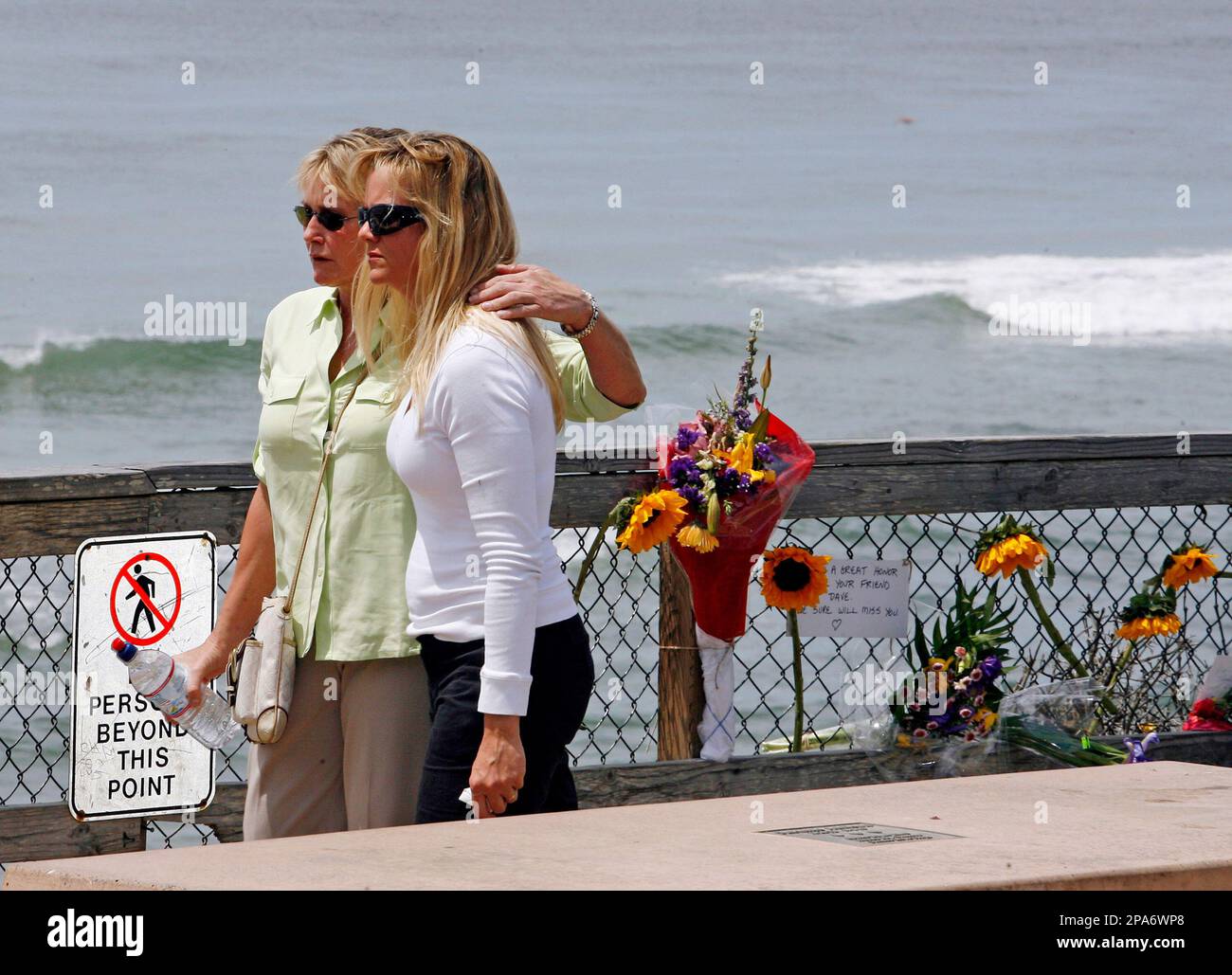 Jan Rhoades, left, and Stephanie Martin, right, walk away after putting