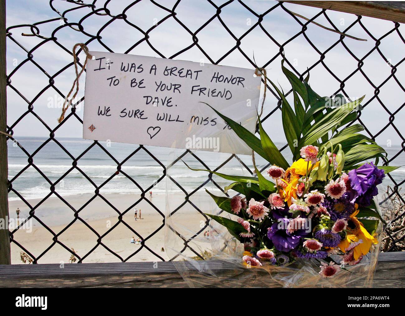 Flowers and a note hang as a memorial to shark attack victim David
