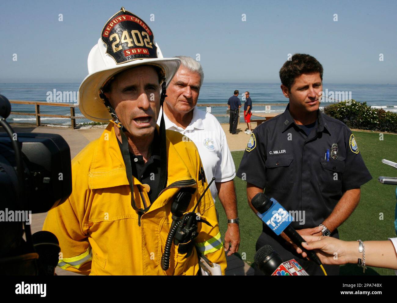Solana Beach Fire Department deputy chief Dismas Abelman, left, talks