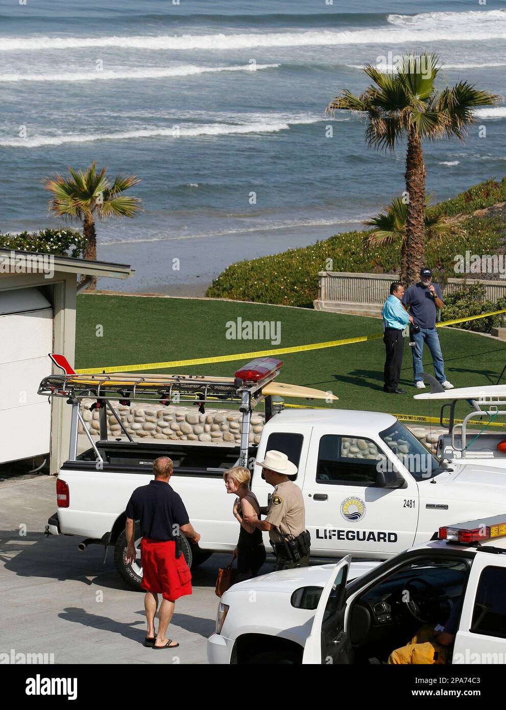 An unidentified family member of a shark attack victim is comforted by