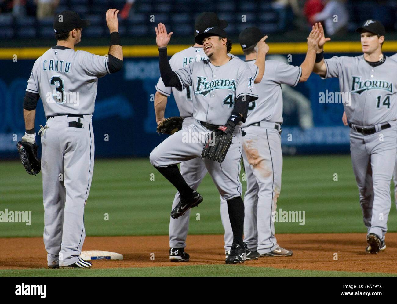 Florida Marlins' Alfredo Amezaga (4) celebrates with Cantu (3) as