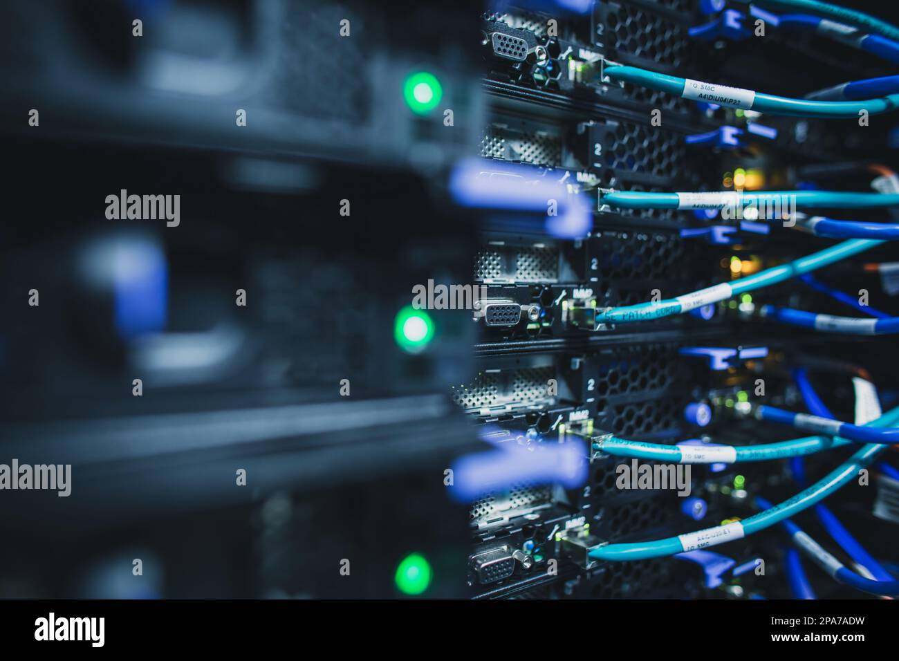 IT engineer standing before working server rack doing routine ...