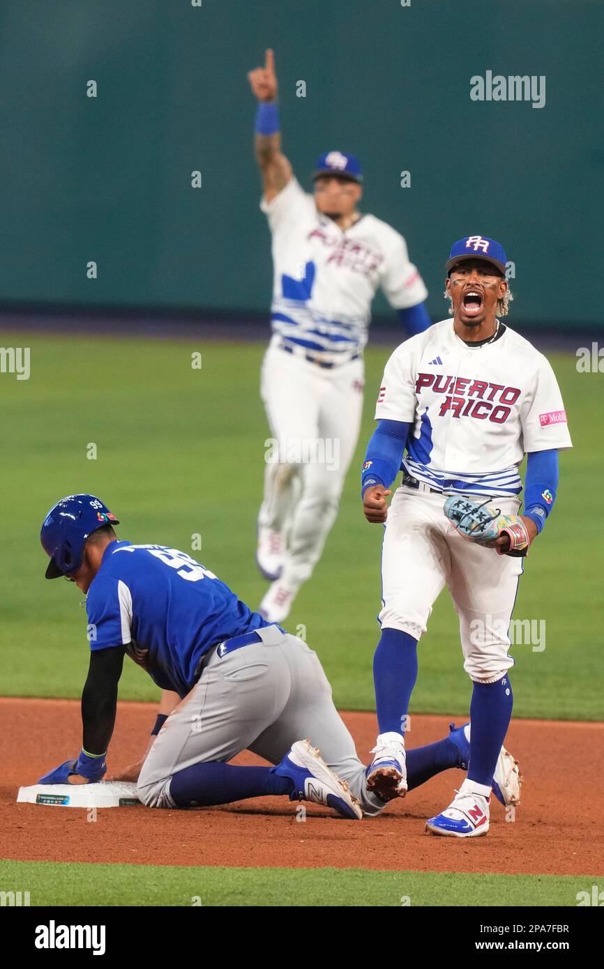 Puerto Rico infielder Francisco Lindor, right, yells after he tagged out  Nicaragua's Juan Diego Montes (99) as Montes tried to steal the second base  during the fourth inning of a World Baseball