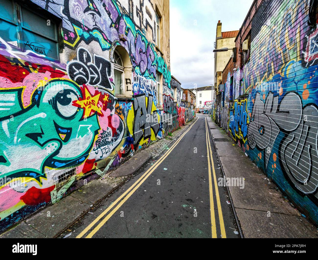 Graffiti covered walls of a narrow alley in the Stokes Croft area of Bristol UK Stock Photo