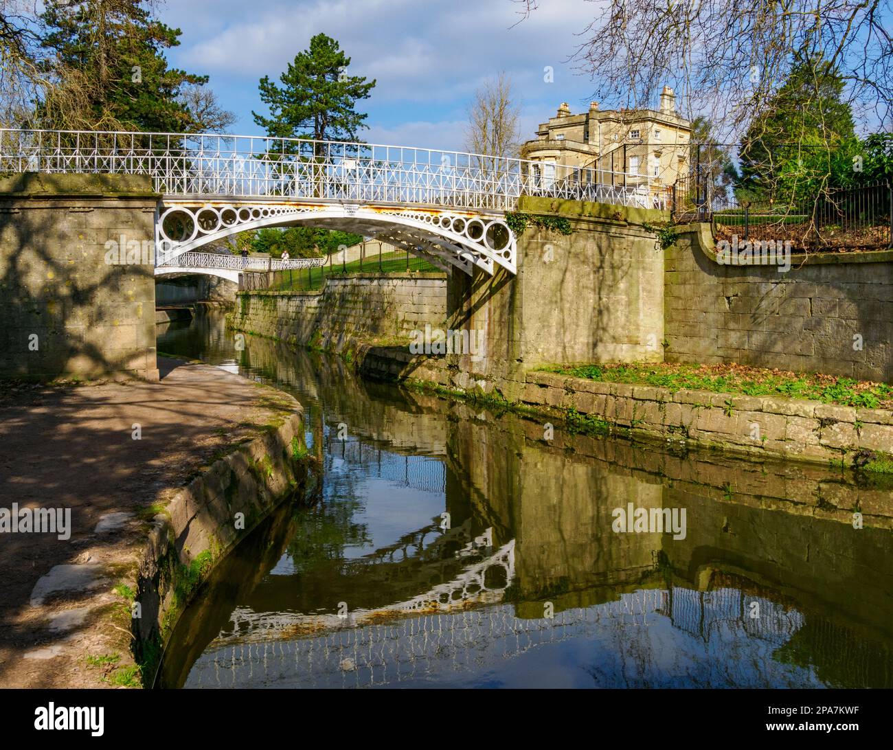 Ornate white painted cast iron bridge over the Kennet and Avon canal at Sydney Gardens in Bath Somerset UK Stock Photo