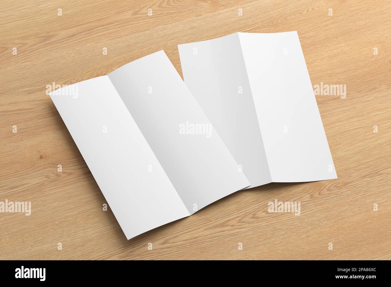 Half-folded flyer A4 vertical booklet mock up on wooden background. Side view Stock Photo