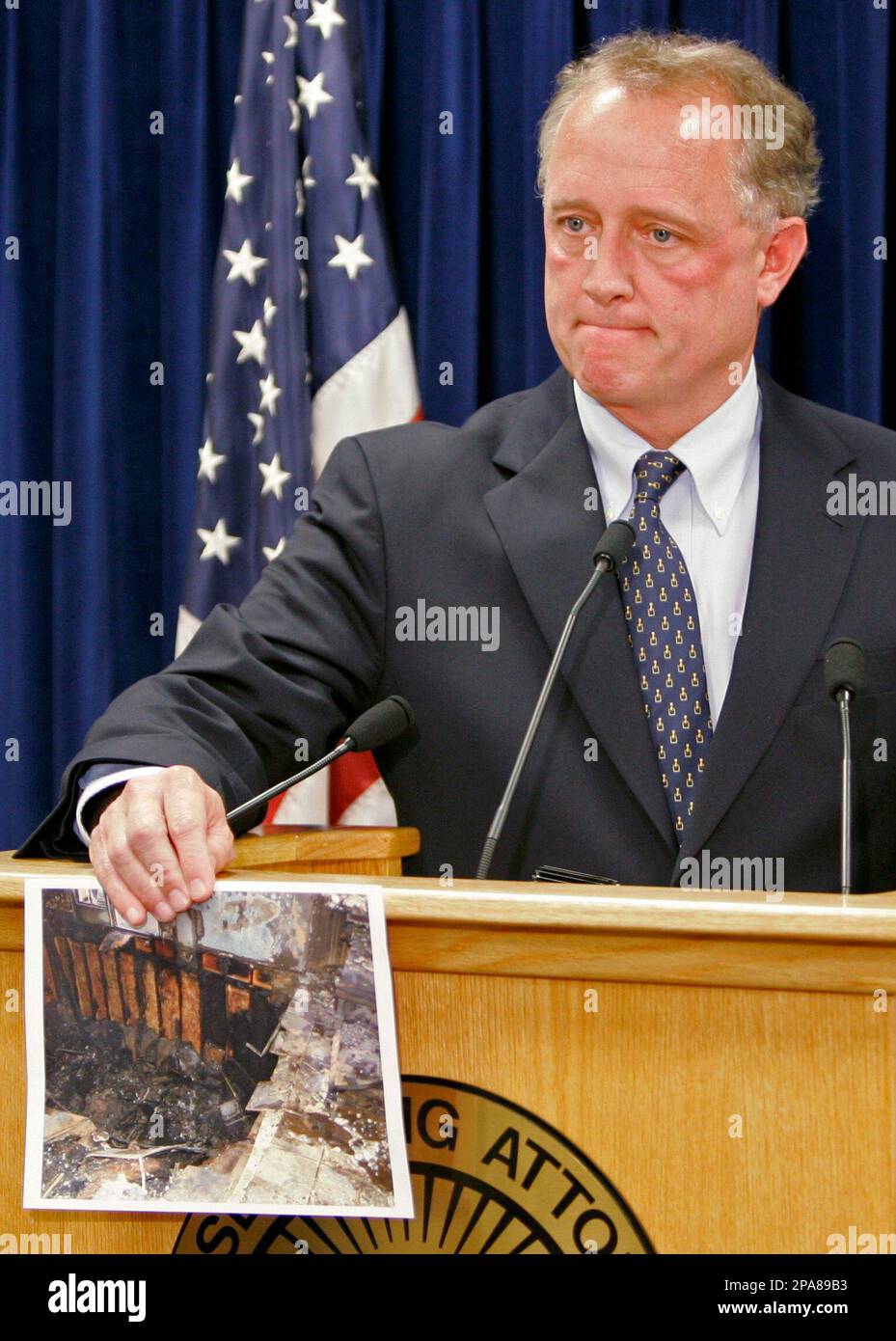 Hamilton County prosecutor Joe Deters holds a photograph of the floor ...
