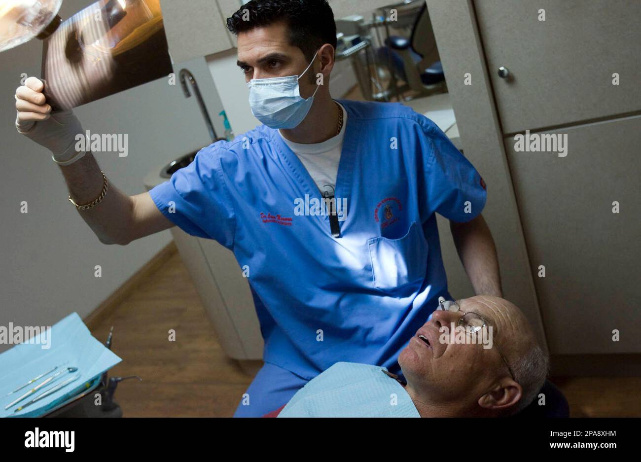 ** ADVANCE FOR MONDAY APRIL 14 **Dr. Cesar Monarrez checks an Xray of