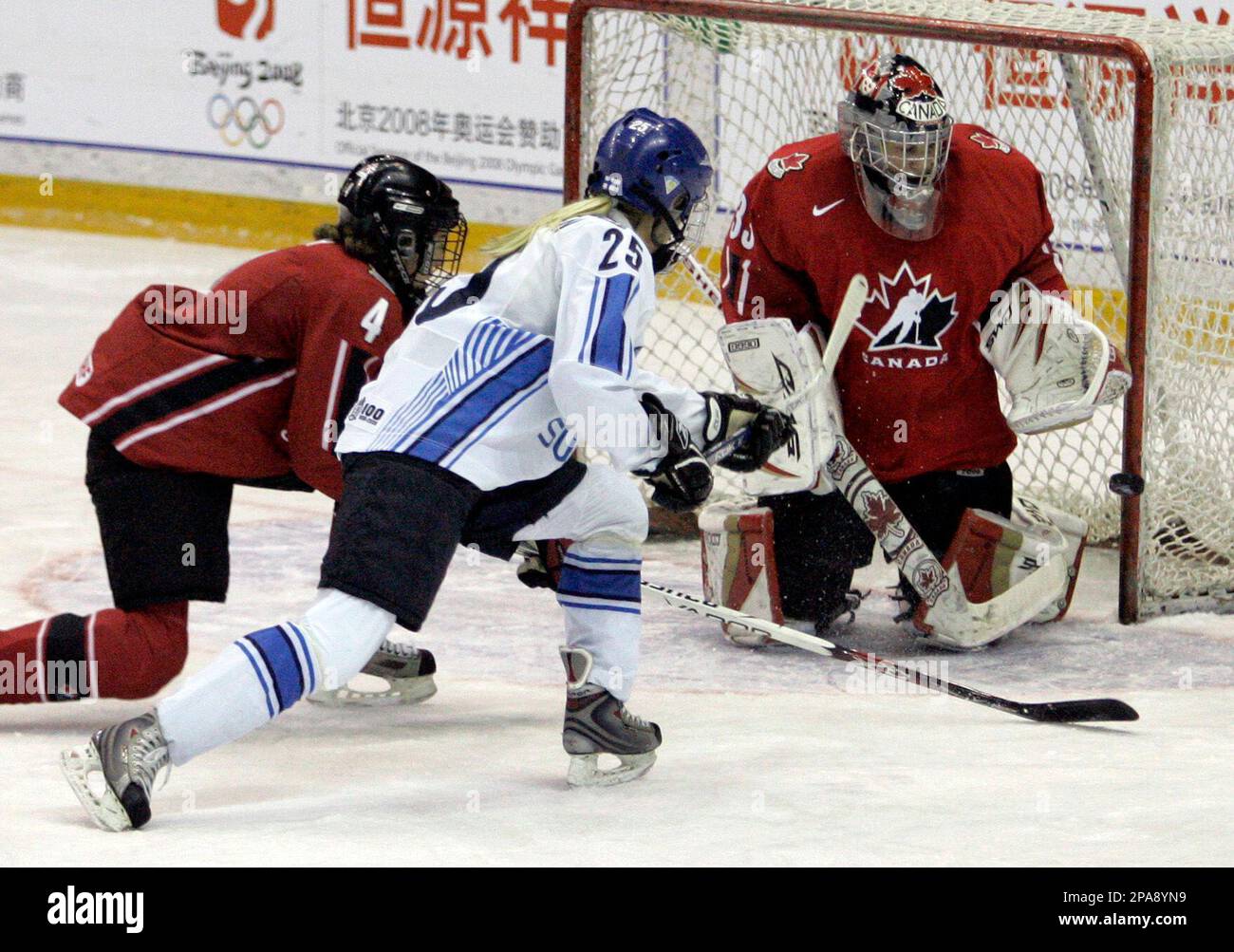 Finland's Anne Helin, center, hits the post with a shot