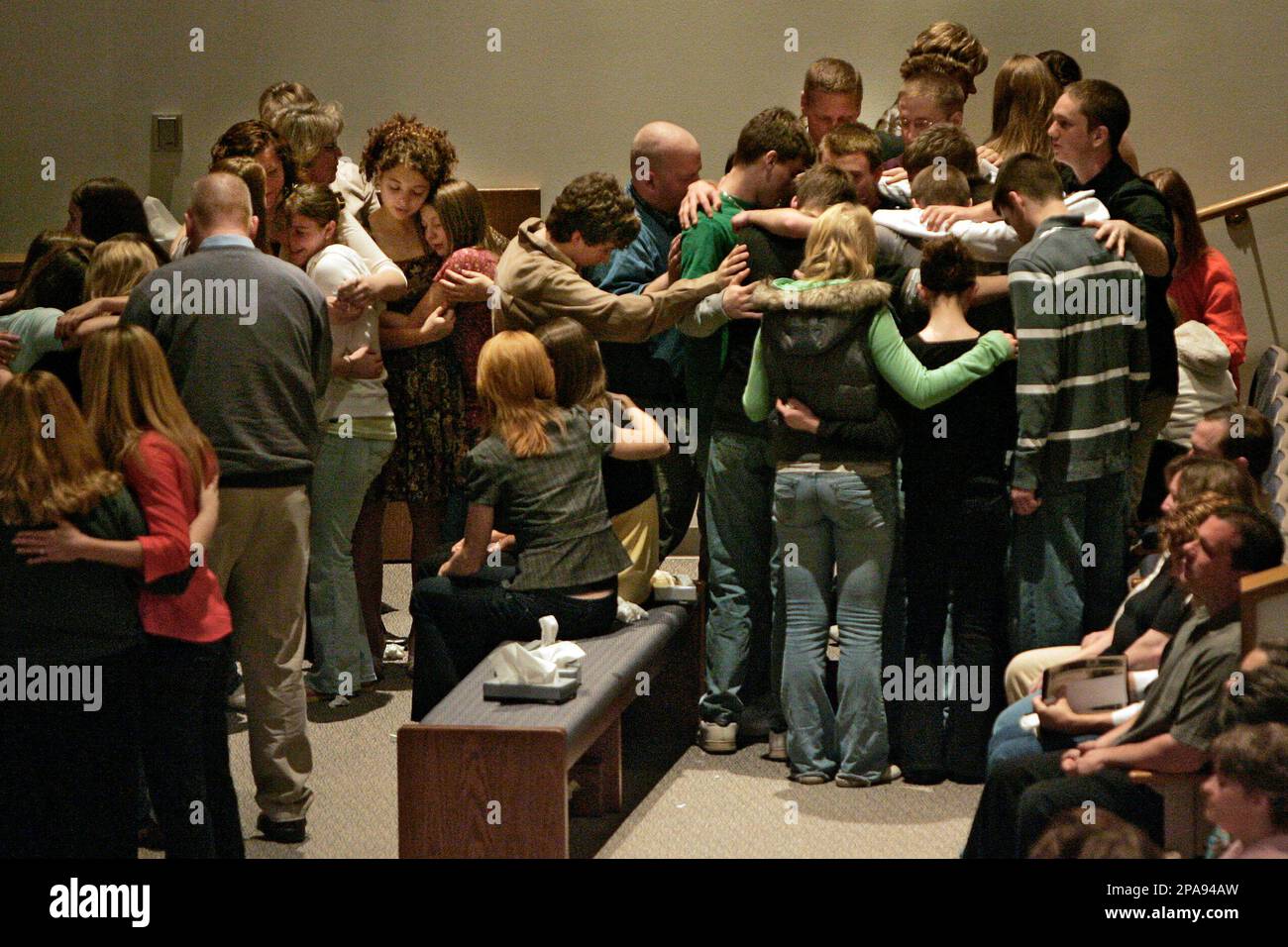 Friends of Ami, Caleb and Billi Romas gather at the front of the Grove City  Church of the Nazarene to grieve their deaths during the church service  Sunday, April 6, 2008. The