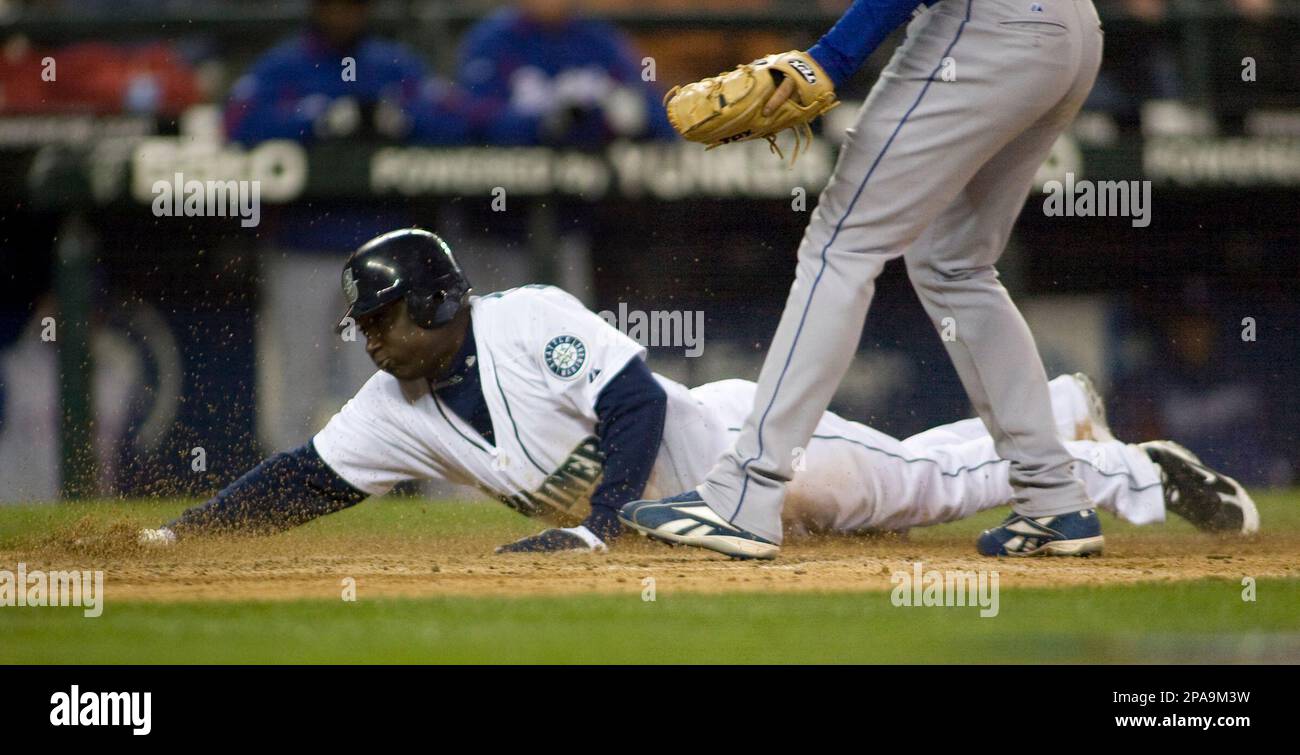 Jason Benoit Rangers Seattle Mariners' Yuniesky Betancourt, left, scores on a wild pitch ...
