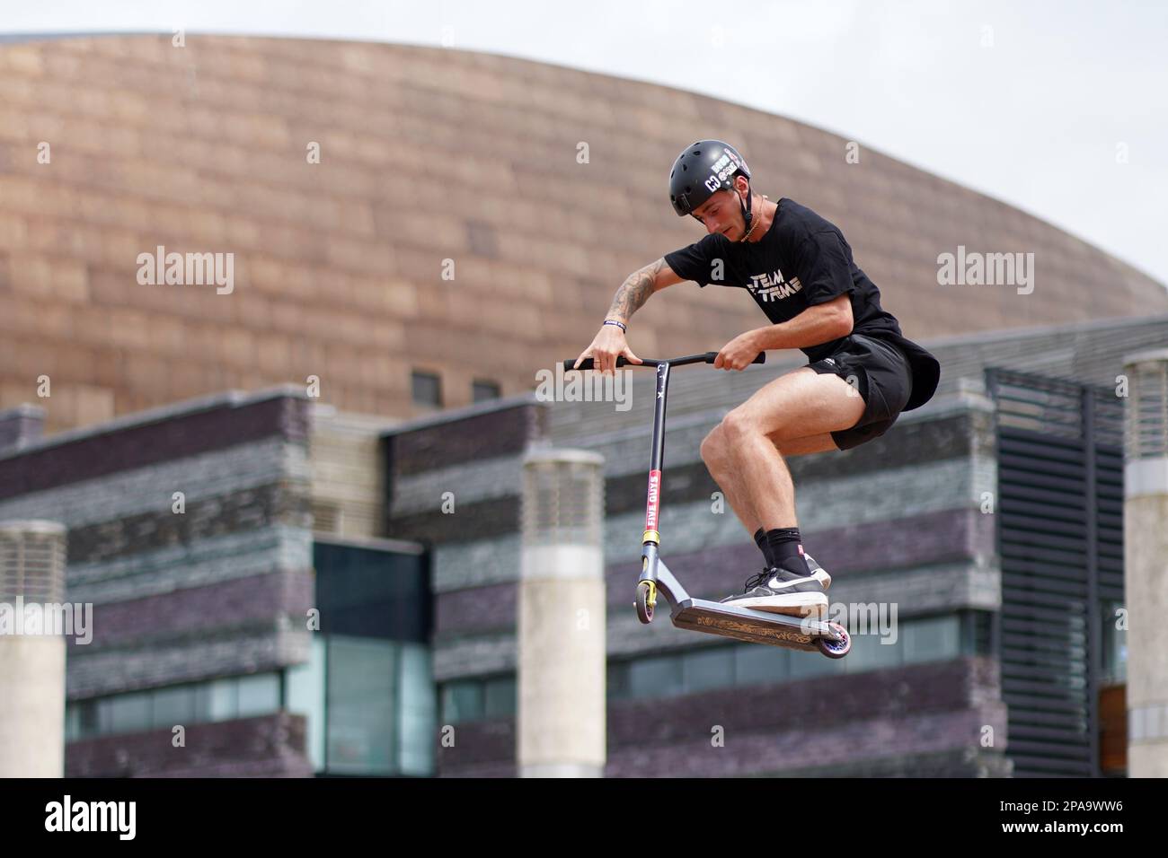 Members of Team Extreme performing Scooter tricks on the half pipe at
