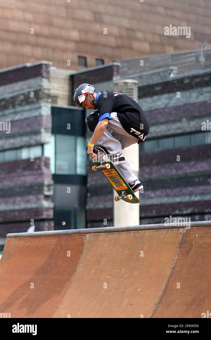 Members of Team Extreme performing Skateboard tricks on the half pipe