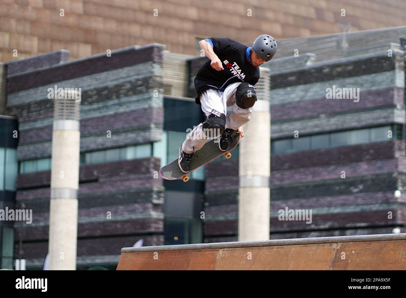 Members of Team Extreme performing Skateboard tricks on the half pipe