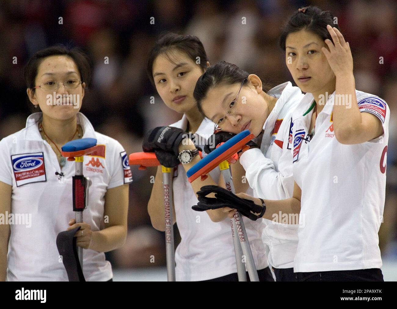 From left, Chinas lead Yan Zhou, second Qingshuang Yue, skip Bingyu Wang and third Yin Liu watch Team Canada during a timeout in the gold medal game at the womens World Curling