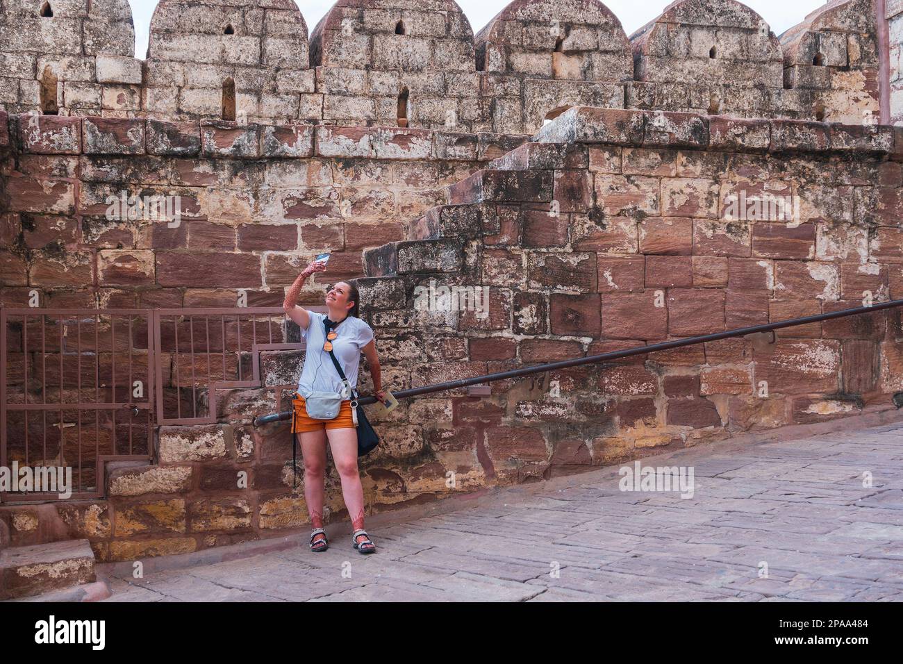 Jodhpur, Rajasthan, India - 19th October 2019 : Foreigner woman tourist taking photograph of famous Mehrangarh fort, Mehrangarh Fort is UNESCO site. Stock Photo