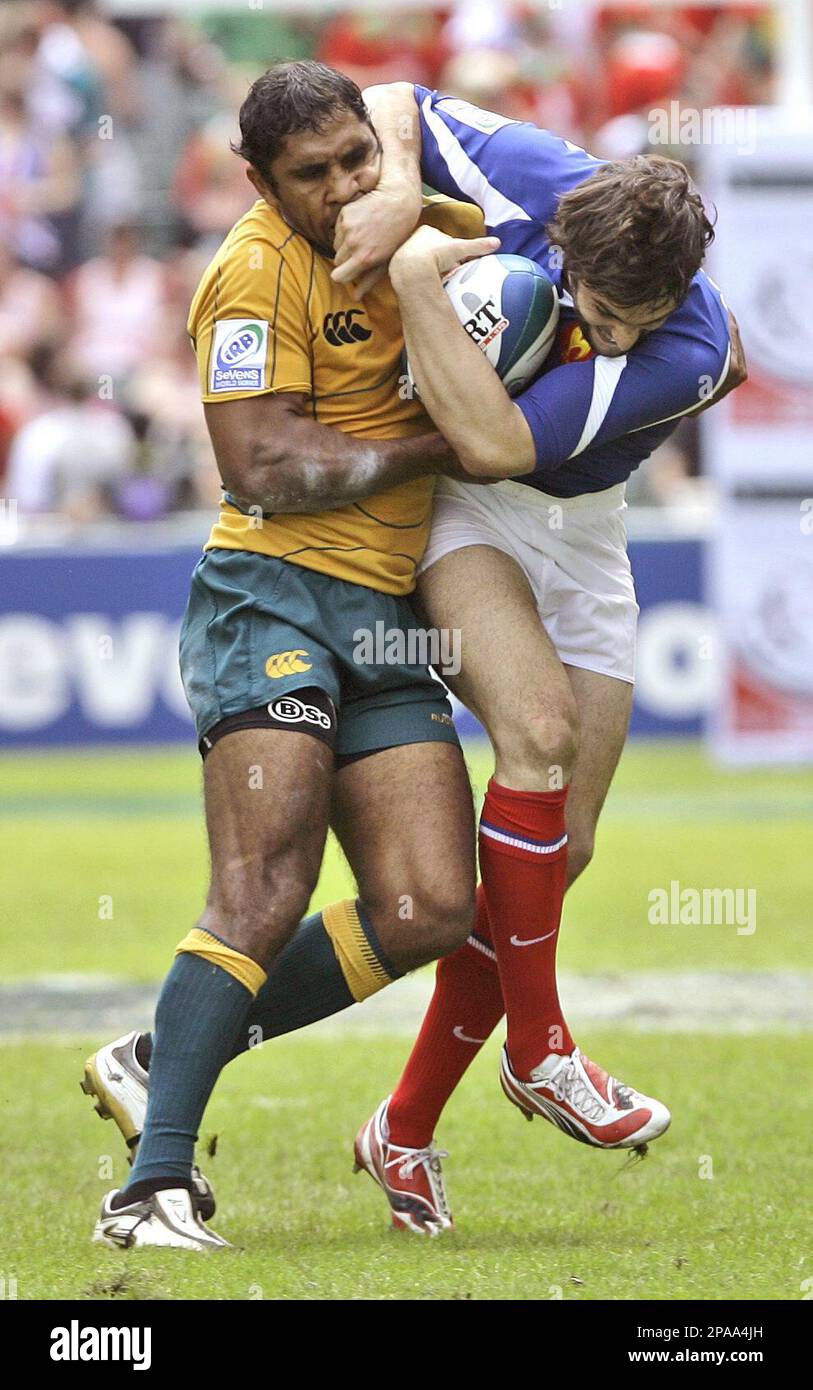 Andrew Walker, left, of Australia is tackled by Thomas Combezou of France  during the second day of the Hong Kong Rugby Sevens tournament in Hong Kong  Saturday, March 29, 2008. Australia won